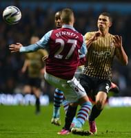 Aston Villa's Joe Bennett (L) challenges Bradford City's Nahki Wells at Villa Park, Birmingham, on January 22, 2013